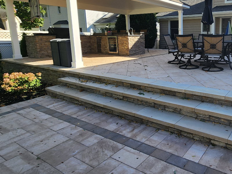 riased patio with outdoor kitchen and pavilion